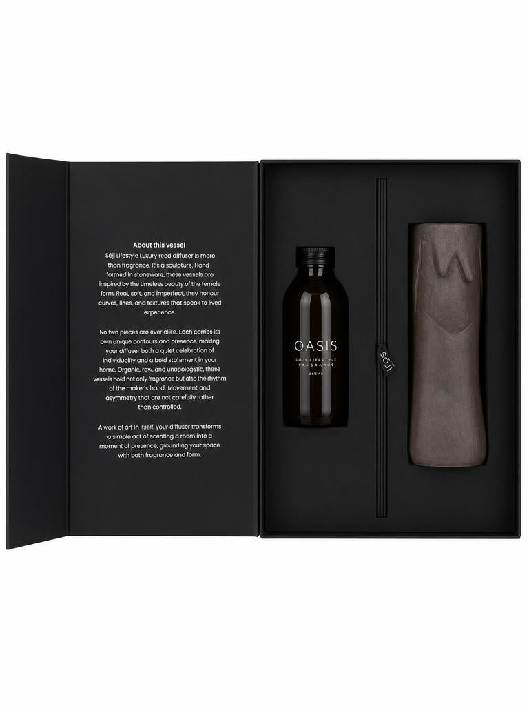 SŌJI Oasis reed diffuser featuring fragrance oil, black reeds and a handcrafted sculptural stoneware vessel presented in a luxury gift box.