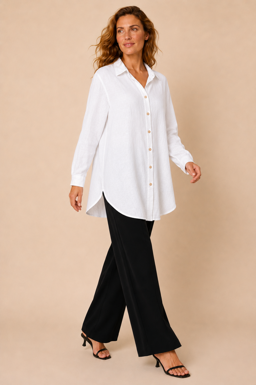 Suzy D Soraya linen long shirt with side pockets in white worn by a model, in motion — Boetiek, Cape Town