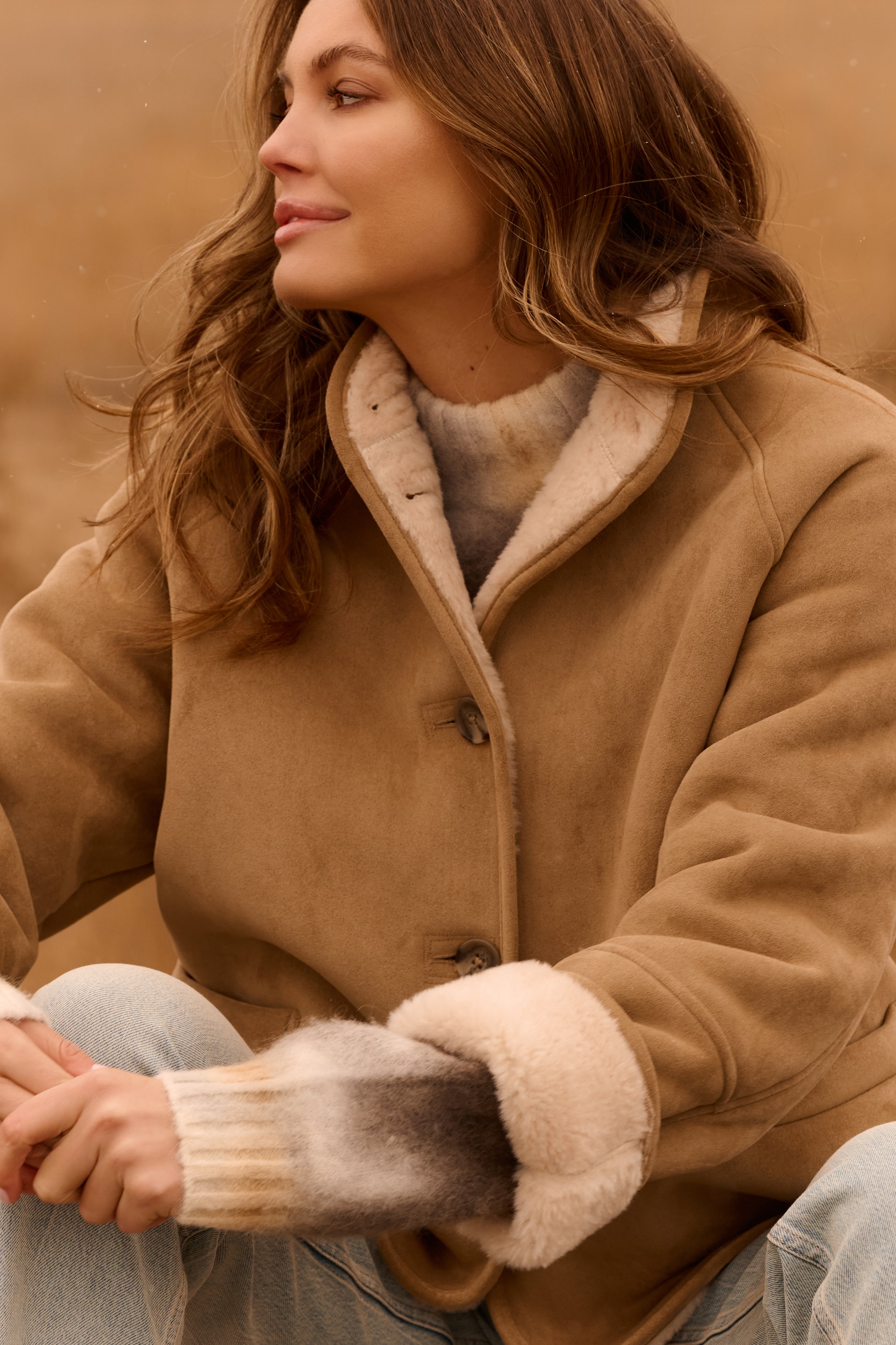 Close-up of the YAYA Faux Lammy Coat with Raglan Sleeves in sand featuring a soft faux shearling lining, button-front closure and turned-back cuffs.