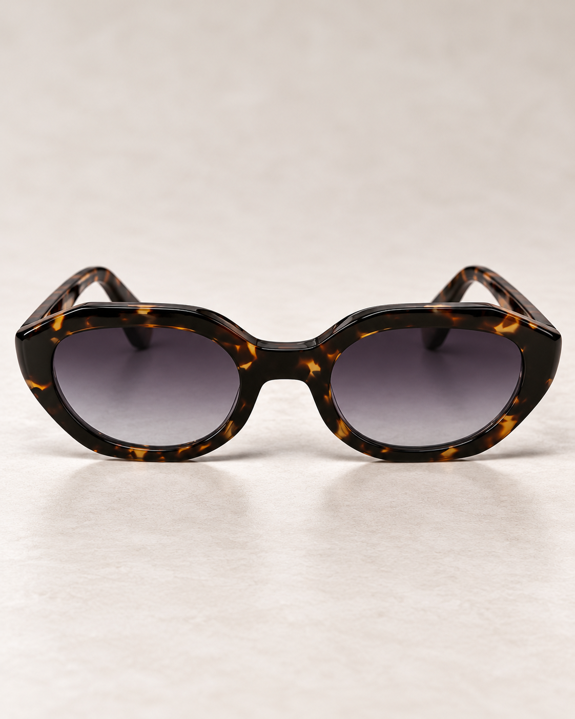 YAYA Florence Sunglasses in tortoiseshell, featuring a glossy brown patterned oval frame and dark gradient lenses