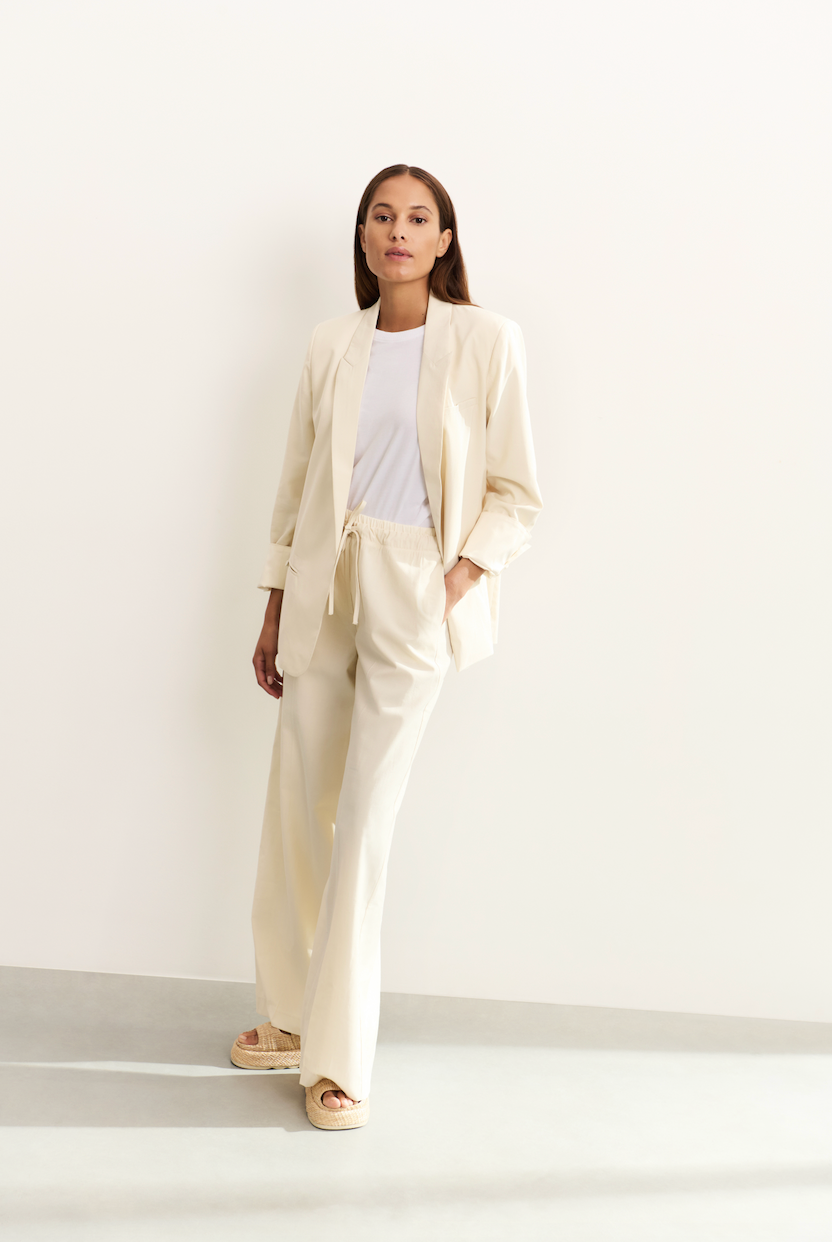 Model wearing YAYA wide leg trousers in off white front view